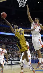 Kim English (24) takes a shot as Clemson's Devin Booker (31) defends during the first half. (AP Photo/David Duprey)