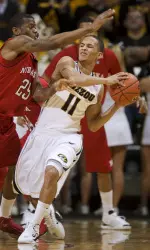 Missouri's Michael Dixon, right, passes the ball as he is defended by Nebraska's Caleb Walker, right, during the first half.
