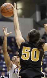 Missouri forward Christine Flores blocks a shot by Xavier guard Special Jennings.