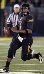 James Franklin looks for a receiver as he scrambles.