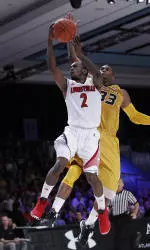 Louisville guard Russ Smith jumps toward the basket while Earnest Ross defends. (AP Photo/John Bazemore)