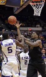 Missouri forward Tony Criswell goes for a rebound between LSU's Shavon Coleman (5) and Johnny O'Bryant III (2) during the first half. (AP Photo/Bill Feig)