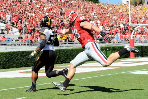 Missouri Tigers defensive lineman Michael Sam (52) returns a fumble for a touchdown past Georgia Bulldogs tight end Arthur Lynch (88) during the second quarter at Sanford Stadium. Mandatory Credit: Dale Zanine-USA TODAY Sports