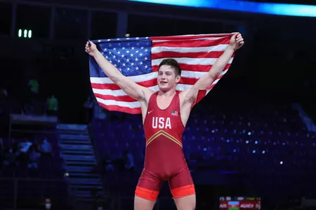 Keegan O'Toole holds the American flag up after winning the Junior World Championship