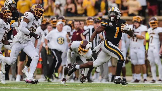 Tyler Badie races away from Central Michigan defenders.
