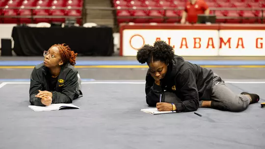 Hannah Horton and Amari Celestine journal before a meet at Alabama.