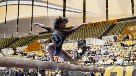 Amari Celestine on beam at Black and Gold Meet