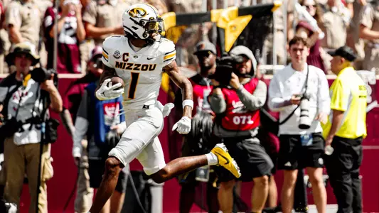 Theo Wease Jr. runs into the endzone after teammate Brady Cook connects with him on a reception