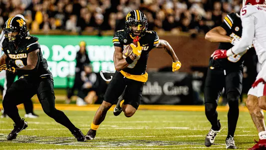 Luther Burden III runs upfield against Oklahoma