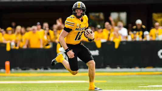 Brady Cook rushes up field against Boston College