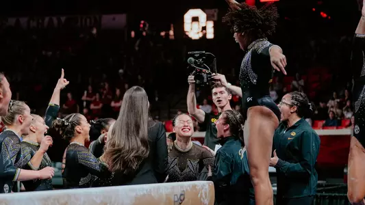 Mizzou gymnastics redshirt senior Helen Hu celebrates with the team after earning a perfect 10 on the balance beam during the team's meet at Oklahoma on Jan. 17, 2025.