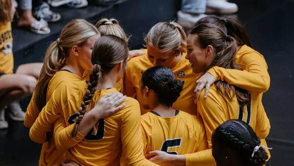 Mizzou volleyball athletes huddle together on the bench against Oklahoma