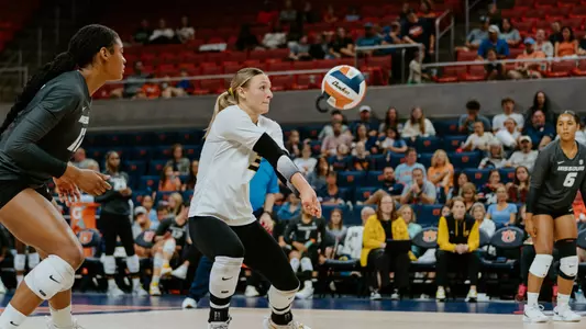 Maya Sands posts a dig, while Caylen watches against Auburn