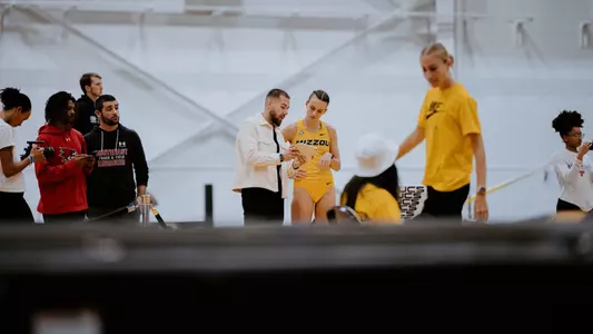 Kristi Perez-Snyman and coach Illiyan Chamov discuss her triple jump at the Dr. Rick McGuire Invitational on Feb. 1, 2025.