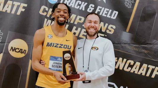 Sophomore Jonathan Seremes and jumps coach Iliyan Chamov posing together after Seremes won the NCAA Indoor national championship on March 15, 2025.