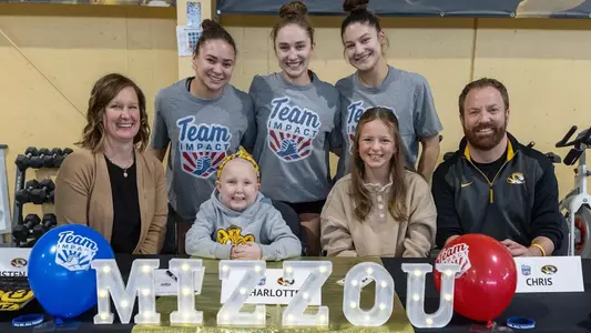 Addison Lawrence, Kyra Burns and Elise Tisler posing with the individual from Team IMPACT that signed with the Mizzou gymnastics team on Feb. 18, 2025.