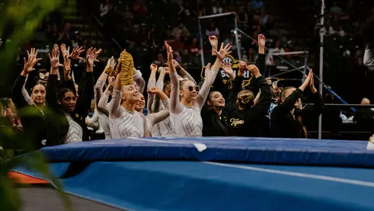 The Mizzou gymnastics team celebrating after a floor performance during the SEC Championship meet on March 22, 2025.