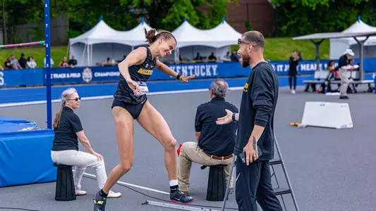 Kristi Perez-Snyman of the Mizzou track and field team celebrating with jumps coach Iliyan Chamov after she won gold in high jump at the 2025 SEC Outdoor Championships.