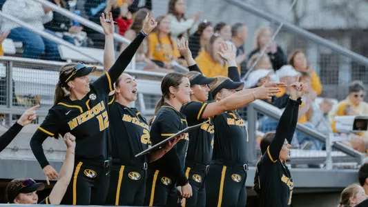 The Mizzou softball dugout celebrates as the Tigers get a hit against Drake at the Mizzou Invitational