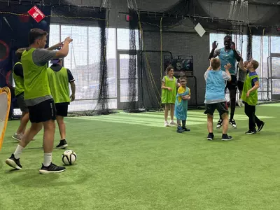 The Men's Soccer team volunteering with local youth