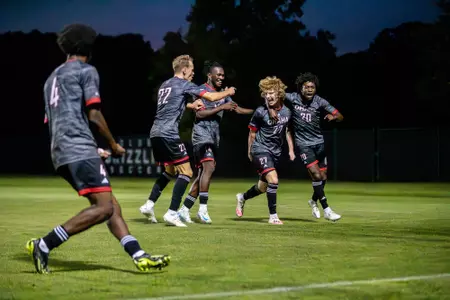 Sophomore Brett Perkins of Gretna (second from right) celebrates scoring his first career goal, the game winner over Oakland University August 22, 2024.