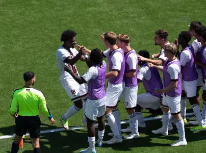 Naz Astwood celebrates with his mates after scoring the eventual game winner against Loyola Chicago