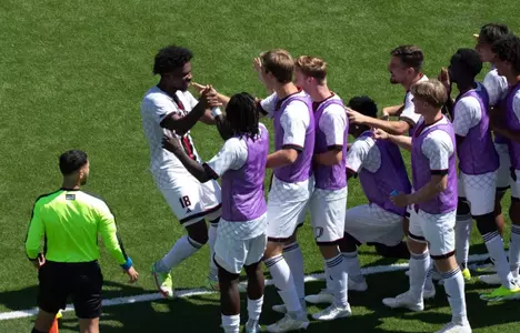 Naz Astwood celebrates with his mates after scoring the eventual game winner against Loyola Chicago