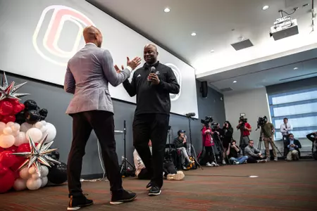 Vice Chancellor/Director of Athletics Adrian Dowell and men's basketball head coach Chris Crutchfield embrace prior to the start of the NCAA Men's Selection Show