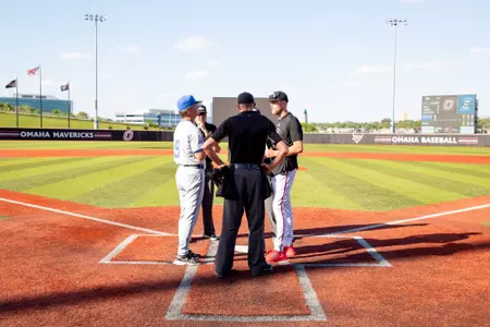 Ed Servais and Evan Porter exchange lineup cards