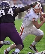 Wisconsin quaterback Brooks<br>Bollinger scrambles during<br>the first quarter<br>as Wildcat defender<br>Salem Simon gives chase Saturday.