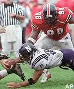 Wide receiver<br>Sam Simmons, bottom,<br>stretches for extra<br>yardage as he is<br>tackled by Indiana<br>defensemen in the<br>second quarter Saturday.