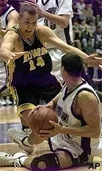 Nate Pomeday beats Iowa's<br>Jacob Jaacks to a<br>loose ball during<br>the first half.