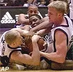 Sean Wink, left, and Evan<br>Eschmeyer battle UTPA's Kirby<br>Lemons for a loose ball<br>during the first half.