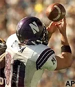John Burden catches<br>a pass in front of<br>Iowa defender D.J. Johnson.