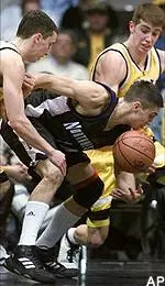 Northwestern's Steve Lepore loses control of the ball between Iowa's Ryan Luehrsmann, left, and Kyle Galloway, rear, during the first half Wednesday night.