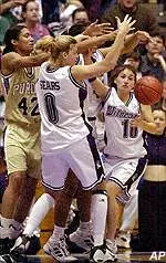 Tami Sears, Leslie Dolland, rear, and Dana Leonard battle for control of the ball with Purdue's Camille Cooper in the second half Sunday.