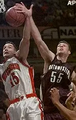 Wisconsin's Andy Kowske and Northwestern's Aaron Jennings battle for a rebound in the first half of the Wildcats' 51-41 loss, Thursday.