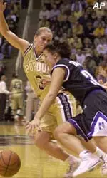 Emily Butler drives around Purdue's Kelly Komara during Sunday's Wildcat loss in West Lafayette.