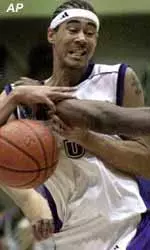 Northwestern's Winston Blake, who scored 20 points in the game, is fouled while driving to the basket during the second half of Saturday's game.