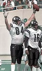 Eric Worley (#84) scored one of Northwestern's five touchdowns in its win at UNLV. Also pictured is Jason Wright (#16).