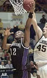 Northwestern's Collier Drayton (32) goes to the basket past Michigan's Chris Young (45) in the second half of their Big Ten game.