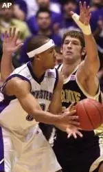 Northwestern forward Tavaras Hardy makes a pass around Purdue center John Allison during the first half.