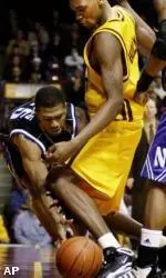 Jitim Young keeps the ball in play as Minnesota's Jerry Holman defends during the second half Wednesday.