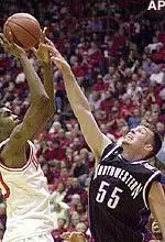 Center Aaron Jennings goes for a block against Indiana forward Jeff Newton during the game on Saturday.