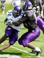 Dominique Price slows down TCU's Corey Connally. TCU defeated Northwestern 48-24.