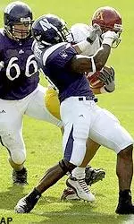 Torri Stuckey and Loren Howard stop Minnesota's Jared Ellerson from turning the corner in the second quarter.