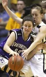 Emily Butler fights off Purdue's Erika Valek during the Wildcats' 74-56 setback.