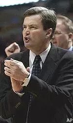 Northwestern head coach Bill Carmody applauds his team's effort against Minnesota, Thursday.