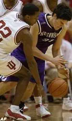 Indiana's Marshall Strickland battles Northwestern's Davor Duvancic for a loose ball during the second half in Bloomington, Ind.