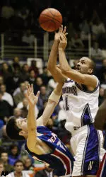 DePaul's Drake Diener fouls T.J. Parker as he goes up for a shot.